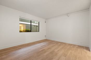 Empty room with window and wooden floor